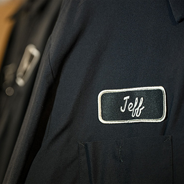 Embroidered workwear with the name Jeff on a dark jacket