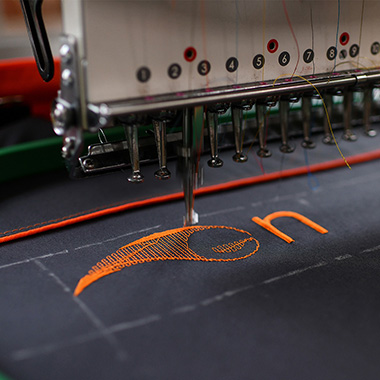 Embroidering a company logo to a piece of workwear