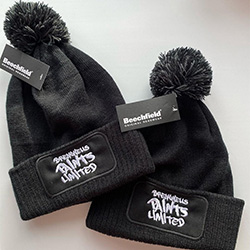 Embroidered work hats with pom-poms on top