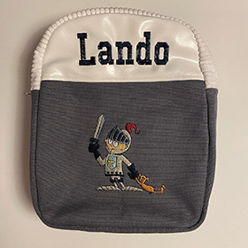 Embroidered bag for Lando with a cartoon knight on the front holding up their sword